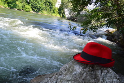 Rear view of hat on rock by sea