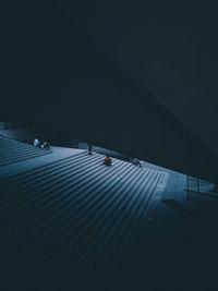 People sitting on steps in city