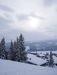 Snow covered landscape against sky