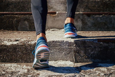 Male sprinter wearing running shoes training outdoors