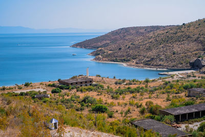 Scenic view of sea and mountains against clear sky