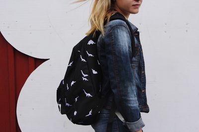 Portrait of a young woman standing on ground