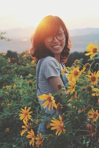 Portrait of smiling woman standing on field