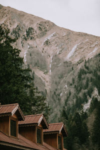 Houses on mountain against sky