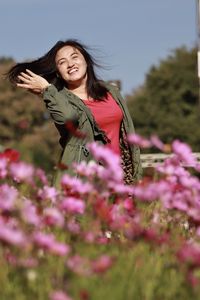Woman standing on flowering plants at field