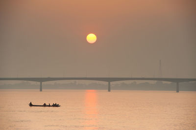 Scenic view of river against sky during sunset