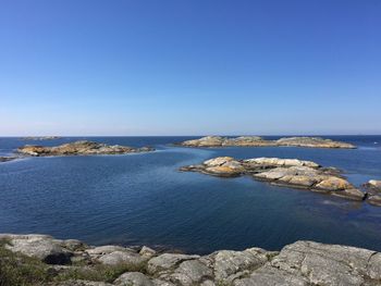 Scenic view of sea against clear blue sky