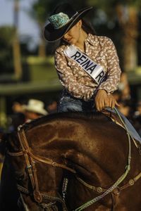 Man riding hat sitting outdoors