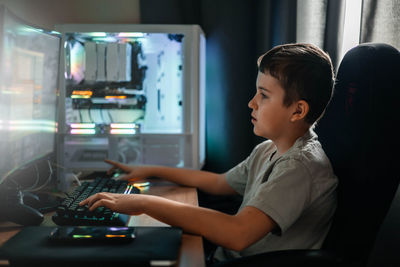 Boy using laptop at home