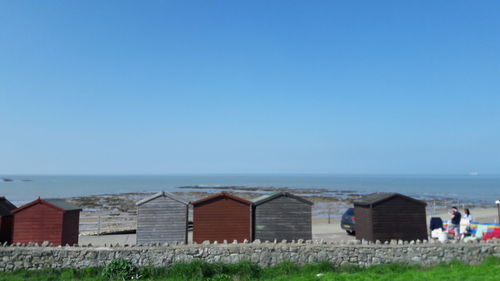 Scenic view of beach against clear blue sky