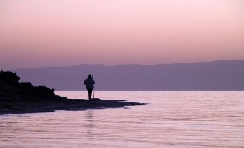 Silhouette of woman standing on mountain