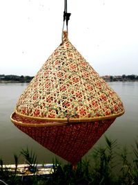 Close-up of clothes hanging in lake against sky