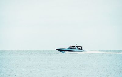 Boat sailing in sea against sky