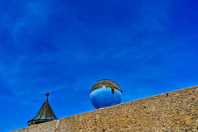 Low angle view of fotoball against blue sky