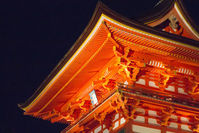 Low angle view of illuminated building at night