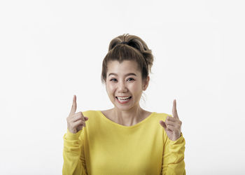 Portrait of smiling mid adult woman against white background