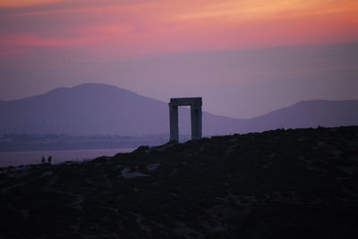 Scenic view of bay against sky at sunset