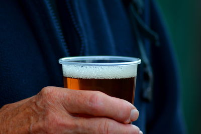 Close-up of hand holding drink