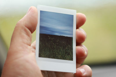 Close-up of person holding camera