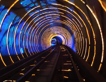 View of train in illuminated tunnel