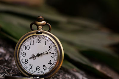 Close-up of pocket watch outdoors