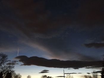 Scenic view of silhouette mountains against sky at night