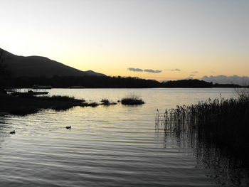 Scenic view of lake at sunset