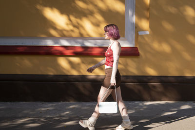 Full length of young woman exercising on stage