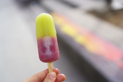 Close-up of hand holding ice cream