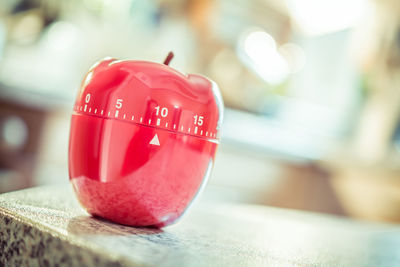 Close-up of apple shape dial on table