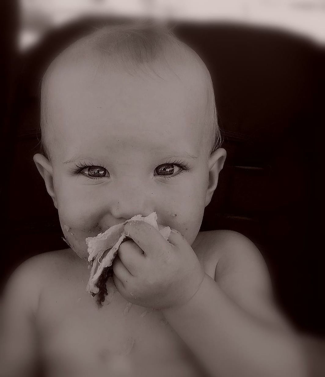 CLOSE-UP PORTRAIT OF SHIRTLESS BOY HOLDING CAMERA