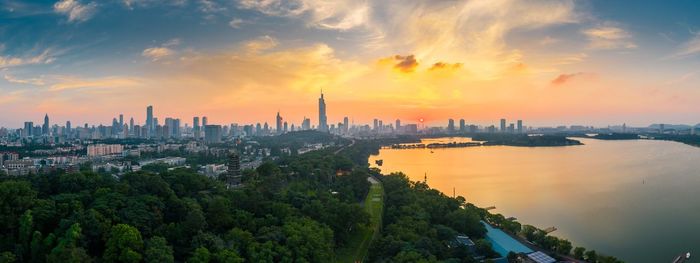 Panoramic view of city buildings during sunset