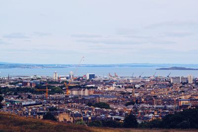 High angle view of townscape by sea against sky