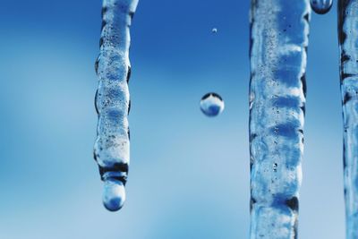 Close-up of ice crystals against blue sky