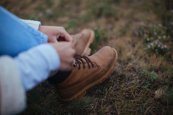 Low section of woman tying boots