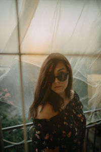 A close up of a young woman wearing sunglasses