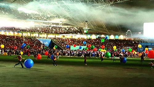 People enjoying soccer field at night