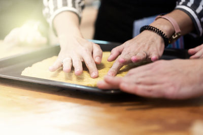 Midsection of person preparing food on table