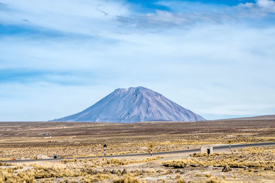 Scenic view of snowcapped mountain against cloudy sky
