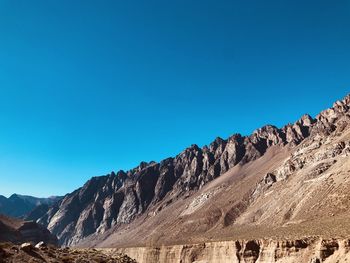 Scenic view of mountains against clear blue sky