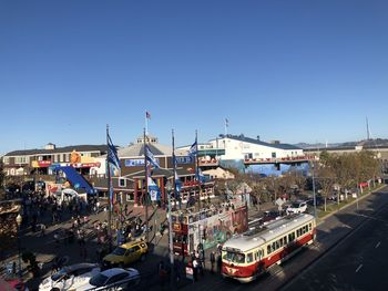 High angle view of amusement park against clear blue sky