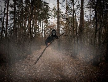 Man jumping in forest