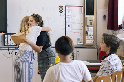 Teacher with students in classroom at the end of school year