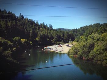 Scenic view of lake and trees against blue sky