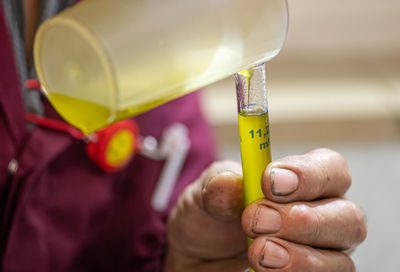 Close-up of hand holding yellow art