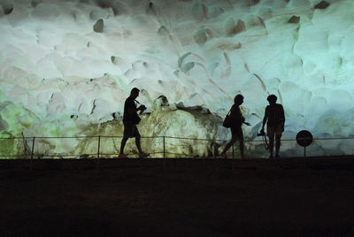 Silhouette people in cave