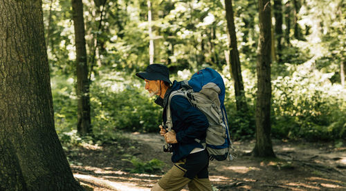 Rear view of man walking in forest