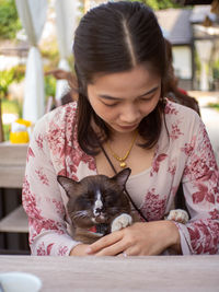 Close-up of young woman with dog