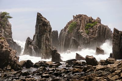 Panoramic view of rocks in sea against sky