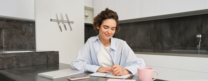 Portrait of young man working at desk in office